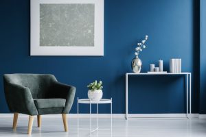 Green,Armchair,Against,The,Wall,With,Silver,Painting,In,Navy